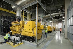 Workers perform maintenance on the generator hub at Duke Health.