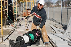 Photo 2. An electrician pulls individual THHN copper conductors in a raceway, which is covered in Table 310.15(B)(16).