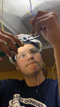 An electrical apprentice is installing a replacement LED driver in a 2-ft &times; 4-ft lay-in luminaire in an office area.