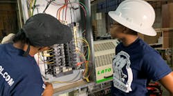 A licensed master electrician and electrical apprentice are working on a 3-phase commercial bolt-on panel and installing a 3-phase industrial edge bander at a woodworking shop in Philadelphia.