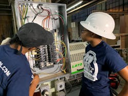 A licensed master electrician and electrical apprentice are working on a 3-phase commercial bolt-on panel and installing a 3-phase industrial edge bander at a woodworking shop in Philadelphia.